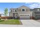 Charming two-story home with a well-manicured lawn and a two-car garage and stone accents at 14836 Jersey Dr, Mead, CO 80542