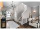 Bright foyer with wood floors and staircase, complemented by a decorative wreath and stylish accents at 14836 Jersey Dr, Mead, CO 80542
