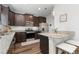 Modern kitchen with granite countertops, stainless steel appliances, and dark wood cabinetry at 14836 Jersey Dr, Mead, CO 80542