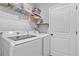 Bright laundry room features a washer and dryer, wire rack, and shelving for optimal storage and organization at 14836 Jersey Dr, Mead, CO 80542