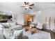 Inviting living room featuring wood floors, a wood accent wall, and cozy seating arrangements at 14836 Jersey Dr, Mead, CO 80542
