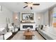 Bright living room featuring modern fireplace with decorative mantle and ample seating at 14836 Jersey Dr, Mead, CO 80542
