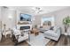 Comfortable living room with fireplace, a ceiling fan, and ample natural light from the window at 14836 Jersey Dr, Mead, CO 80542