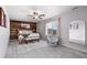 Bright main bedroom features a wood accent wall, ceiling fan, and large window at 14836 Jersey Dr, Mead, CO 80542