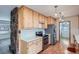 Well-lit kitchen with wooden cabinets, stainless steel appliances, and durable countertops at 4880 S Washington St, Englewood, CO 80113