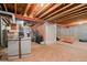 Unfinished basement with exposed beams, concrete walls, and door at 4023 E Geddes Cir, Centennial, CO 80122