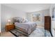 Comfortable bedroom with a decorative rug, neutral walls, and a window with shutter blinds at 4023 E Geddes Cir, Centennial, CO 80122