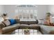 A large and comfortable sectional and many windows allow for a relaxing bright space at 4023 E Geddes Cir, Centennial, CO 80122