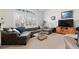 Bright living room features a large sectional couch and a window with plantation shutters at 4023 E Geddes Cir, Centennial, CO 80122