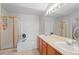 Well-lit bathroom features a double vanity, a soaking tub, and a glass-enclosed shower at 4023 E Geddes Cir, Centennial, CO 80122