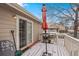 Outdoor patio with a red umbrella and barbecue grill, adjacent to a sliding glass door at 4023 E Geddes Cir, Centennial, CO 80122