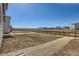 Large backyard featuring a fence and a view of neighboring houses and the open plains at 17467 E 89Th Way, Commerce City, CO 80022