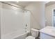 Bathroom featuring bathtub with shower, toilet, vanity, and mirrored wall cabinet at 17467 E 89Th Way, Commerce City, CO 80022