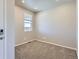 Bedroom showcasing neutral carpet and a window with natural light at 17467 E 89Th Way, Commerce City, CO 80022