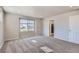 Bedroom with neutral walls and carpet, large windows and attached bathroom at 17467 E 89Th Way, Commerce City, CO 80022
