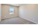 Bedroom with neutral walls, carpeted floor, and window with neighborhood views at 17467 E 89Th Way, Commerce City, CO 80022
