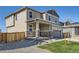 Two-story home with stone accents, a covered front porch, and well-maintained landscaping at 17467 E 89Th Way, Commerce City, CO 80022
