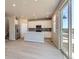 Modern kitchen features white cabinets, stainless steel appliances, and an island for additional counter space at 17467 E 89Th Way, Commerce City, CO 80022