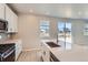 Modern kitchen showcasing an island, stainless steel appliances, and backyard view at 17467 E 89Th Way, Commerce City, CO 80022