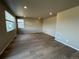 Spacious living room with hardwood flooring and natural light streaming through the windows at 17467 E 89Th Way, Commerce City, CO 80022