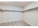 Walk-in closet featuring carpeted floor and built-in shelves at 17467 E 89Th Way, Commerce City, CO 80022