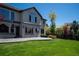 This home features a patio with plenty of space for outdoor seating, green grass, and mature trees at 9445 Aspen Hill Cir, Lone Tree, CO 80124