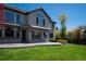 Expansive backyard featuring a well-manicured lawn, patio, and lush landscaping, perfect for outdoor entertaining at 9445 Aspen Hill Cir, Lone Tree, CO 80124