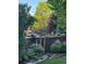 Landscaped backyard with privacy fence, mature trees, and glimpse of home at 9445 Aspen Hill Cir, Lone Tree, CO 80124