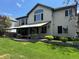 The backyard features a patio with comfortable seating, green grass, and a beautiful exterior view of the home at 9445 Aspen Hill Cir, Lone Tree, CO 80124