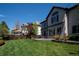Lush backyard featuring a well-manicured lawn, gorgeous landscaping, and a spacious patio, perfect for entertaining at 9445 Aspen Hill Cir, Lone Tree, CO 80124