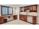 Basement kitchenette with wooden cabinets and drawers and a small bar area with a mini fridge at 9445 Aspen Hill Cir, Lone Tree, CO 80124