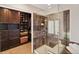 Bright bathroom featuring a tiled shower with a glass door and a custom closet at 9445 Aspen Hill Cir, Lone Tree, CO 80124