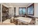 Bathroom featuring a soaking tub, tiled shower, and window with shutter, providing a spa-like experience at 9445 Aspen Hill Cir, Lone Tree, CO 80124