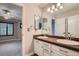 Bathroom with a double sink vanity, large mirror, and modern lighting, offering a functional space at 9445 Aspen Hill Cir, Lone Tree, CO 80124