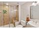 Bathroom features a tiled shower with glass doors, toilet, and a sink with a mirrored cabinet at 9445 Aspen Hill Cir, Lone Tree, CO 80124