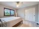 Bedroom with carpet, ceiling fan, window with shutters, and a large bed against a neutral color scheme at 9445 Aspen Hill Cir, Lone Tree, CO 80124