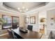 Elegant dining room featuring tray ceilings, stylish furnishings, and a view into the kitchen at 9445 Aspen Hill Cir, Lone Tree, CO 80124