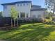 Beautifully landscaped backyard with lush lawn and garden beds surrounding home at 9445 Aspen Hill Cir, Lone Tree, CO 80124