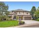 Beautiful two-story home with stone accents, mature trees, and a well-manicured lawn at 9445 Aspen Hill Cir, Lone Tree, CO 80124