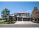 Stunning two-story home featuring stone accents, a three-car garage, and beautifully landscaped front yard at 9445 Aspen Hill Cir, Lone Tree, CO 80124