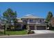 An attractive home with a three-car garage, stone accents, a well-kept lawn, and beautiful curb appeal at 9445 Aspen Hill Cir, Lone Tree, CO 80124