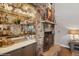 Close-up view of stone fireplace with built-in bar and decorative mantle at 9445 Aspen Hill Cir, Lone Tree, CO 80124