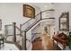 Welcoming foyer with dark hardwood flooring, elegant staircase, and a charming console table at 9445 Aspen Hill Cir, Lone Tree, CO 80124