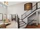 Grand foyer with soaring ceilings, elegant staircase, and views into the living room creates a striking entry at 9445 Aspen Hill Cir, Lone Tree, CO 80124