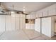 Spacious garage featuring custom white cabinets and ample storage at 9445 Aspen Hill Cir, Lone Tree, CO 80124