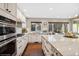 Spacious kitchen boasts stainless appliances, island with marble countertop, and hardwood floors at 9445 Aspen Hill Cir, Lone Tree, CO 80124