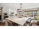 Bright kitchen featuring an oversized island, stainless steel appliances, and a cozy breakfast nook at 9445 Aspen Hill Cir, Lone Tree, CO 80124