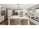 Spacious kitchen with an oversized island, stainless steel appliances, and a window bench seat at 9445 Aspen Hill Cir, Lone Tree, CO 80124