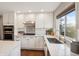 Bright kitchen features white cabinets, stainless steel appliances and marble countertops at 9445 Aspen Hill Cir, Lone Tree, CO 80124