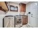 Well-equipped laundry room with modern washer and dryer, sink, storage cabinets, and ample counter space at 9445 Aspen Hill Cir, Lone Tree, CO 80124